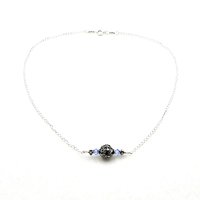 a small horizontal pendant with a sterling silver filigree Bali bead in the center