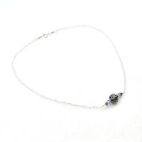 with two tiny light sapphire blue crystal beads and tiny Bali beads on each side