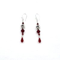 silver plated skull beads accented with deep red crystal bicone shaped beads and teardrop charms