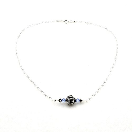 a small horizontal pendant with a sterling silver filigree Bali bead in the center