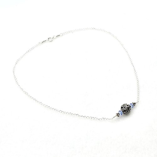 with two tiny light sapphire blue crystal beads and tiny Bali beads on each side